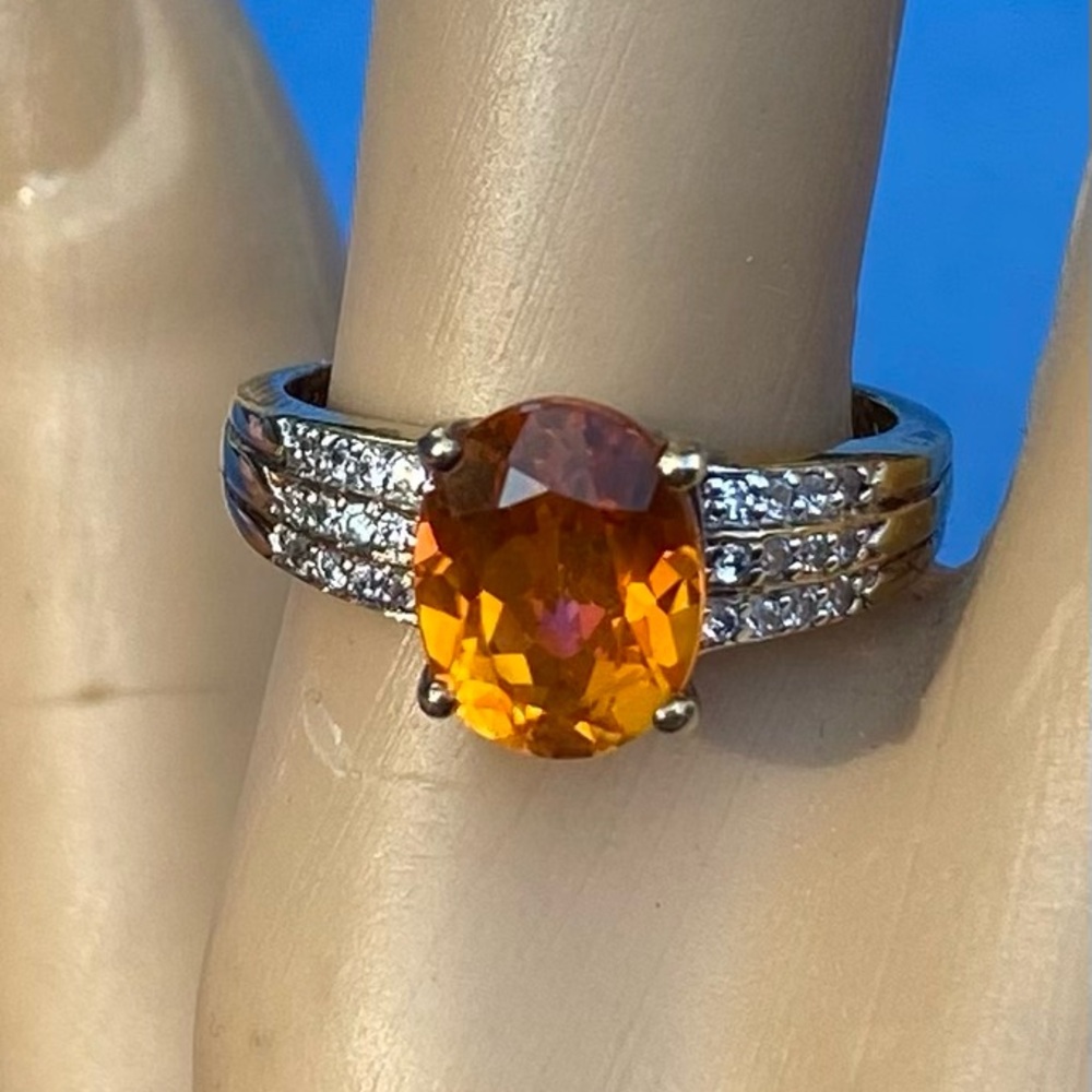 C26: 2.75 mystic orange & white topaz ring. Center 2.5 ct oval - like sunstone